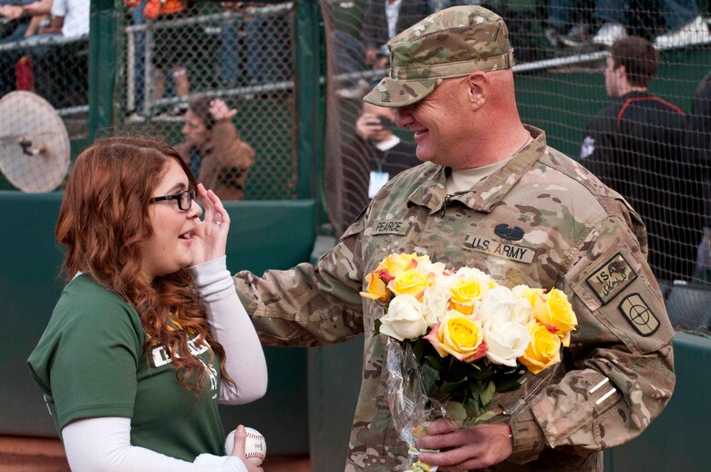 OAKLAND, Calif. — Allie Pearce wipes away tears as she talks with her dad, Army Specialist Scott Pearce, on her 16th birthday before the Oakland Athletics game against the San Francisco Giants at O.co Coliseum here, June 22, 2012.