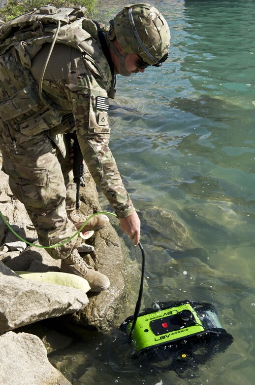 AFGHANISTAN — Spc. Matthew Jones launches a remotely controlled submersible at Dahla Dam, here, June 11, 2012. Jones is a member of 569th Engineer Dive Detachment, which deployed to Afghanistan to support the U.S. Army Corps of Engineers Afghanistan Engineer District-South, by conducting hydrographical surveys and inspections of underwater structures at Kajaki and Dahla Dams.