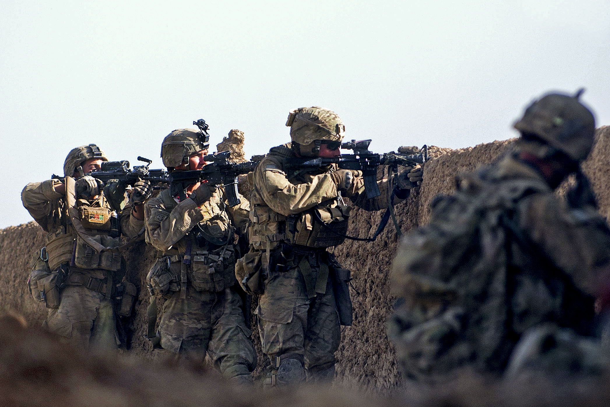 U.S. paratroopers fire at insurgent forces during a