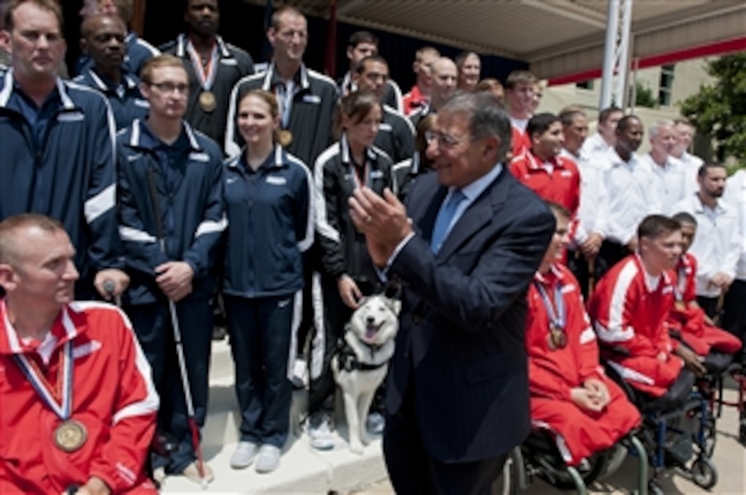 Secretary of Defense Leon E. Panetta applauds the athletes at the 2012 Warrior Games Recognition Ceremony in the Pentagon Center Courtyard in Arlington, Va., on June 25, 2012.  