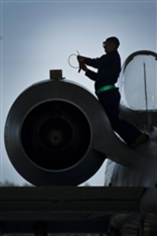 U.S. Air Force Staff Sgt. Jonathan Torres checks the engine oil while conducting a post-flight check on an A-10 Thunderbolt II aircraft at Eielson Air Force Base, Alaska, on June 18, 2012.  Torres is a crew chief with the 51st Aircraft Maintenance Squadron.  