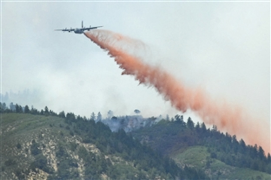 A C-130 aircraft equipped with a modular firefighting system drops retardant on a section of the Waldo Canyon fire near Colorado Springs, Colo., June 26, 2012. Four of these aircraft, assigned to the Air Force's 302nd and 153rd airlift wings, are helping civil authorities combat the fire. The 302nd Airlift Wing is based on Peterson Air Force Base, Colo., and the 153rd Airlift Wing is part of the Wyoming Air National Guard.