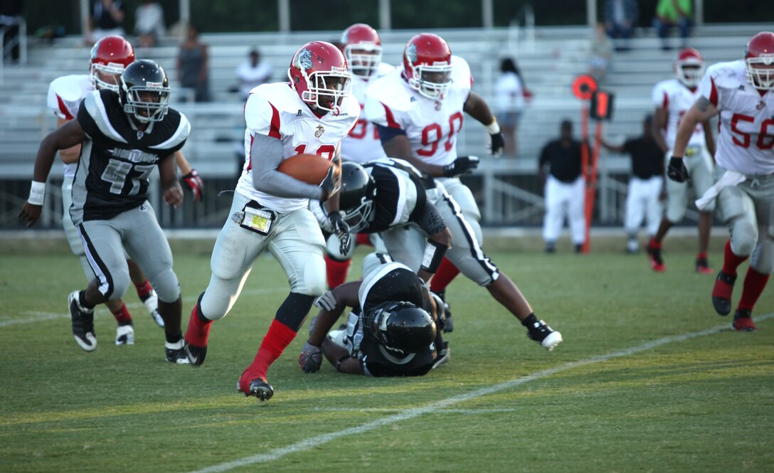 P.J. Thomas, running back for the Bulldogs, runs to the outside and lloks to break up-field for a big run against the Nighthawks aboard Marine Corps Base Camp Lejeune June 16. The Bulldogs won the game 44-0 and improved their record to 3-0 for the season.