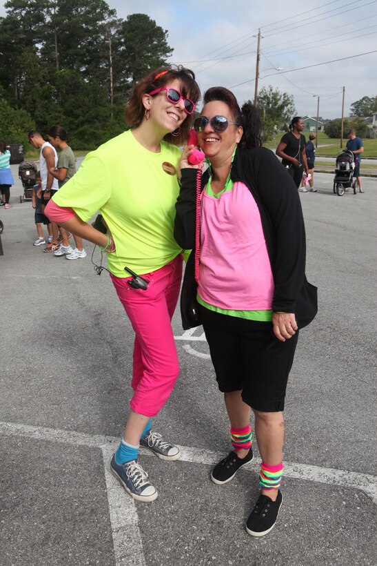 Lorraine Fuller, left, a recreational specialist, and Judith Lopez, a recreational assistant, helped coordinate and supervise the 80s-themed Family Fun Run hosted by the Tarawa Terrace Community Center aboard the Marine Corps Base Camp Lejeune housing area recently. The event had 88 returning runners and 62 new registrants. 

