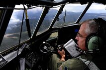 Lt. Col. Barry Curtis, a MAFFS-trained pilot with the 302 Airlift Wing, Peterson Air Force Base, Colo. flies a C-130 Hercules aircraft in support of the U.S. Forest Services fire suppression efforts in the Rocky Mountain area June 27, 2012.   (U.S. Air Force photo/ Staff Sgt. Stephany D. Richards)