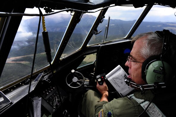 Lt. Col. Barry Curtis, 302nd Airlift Wing MAFFS-trained pilot flies a C-130 Hercules aircraft in support of the U.S. Forest Services fire suppression efforts in the Rocky Mountain area June 27, 2012. Some of the obstacles the teams have encountered with the wildfires are heat, high elevation and mountainous terrain. (U.S. Air Force photo/Staff Sgt. Stephany D. Richards) 

