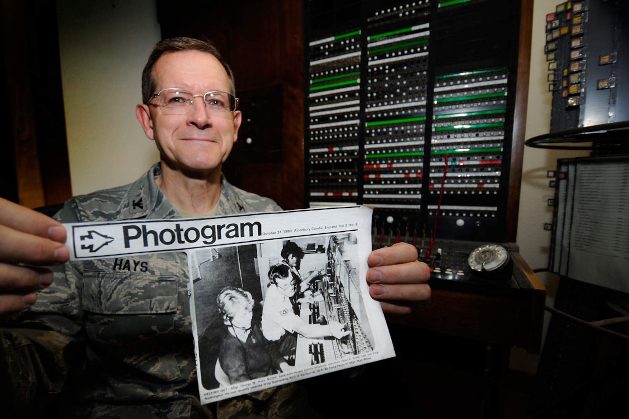 Air Force Col. George Hays holds a newspaper clipping from 1980 when he won non-commissioned officer of the quarter. (U.S. Air Force photos/Staff Sgt. Cynthia Spalding)
