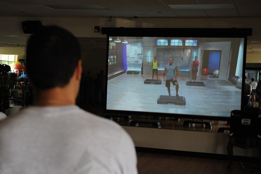 An Airman prepares to begin the stomp class during the opening of the Fitness on Request kiosk on Barksdale Air Force Base, La., June 28. The new kiosk offers stomp, kinetics, fusion, spin and kick boxing classes for Airmen and their families. The kiosk is located in the aerobics room of the base Fitness Center and can be used any time the room is not occupied by a class. (U.S. Air Force photo/Airman 1st Class Micaiah Anthony)(RELEASED)