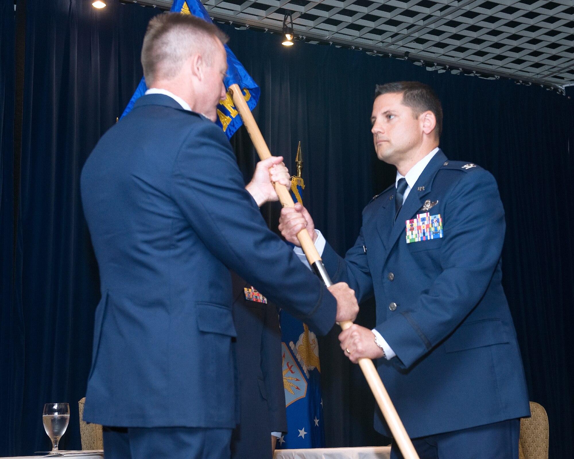YOKOTA AIR BASE, Japan -- Col. Douglas Lamberth, left, 515th Air Mobility Operations Wing commander, passes the guidon to Col. Kenneth Brownell, incoming 515th Air Mobility Operations Group commander, during the 515th AMOG change of command ceremony at Yokota Air Base, Japan, on June 28, 2012. Brownell was the United States Transportation Command liaison officer to the United Nations Command, Combined Forces Command, and U.S. Forces - Korea, Yongsan Garrison, Republic of Korea. (U.S. Air Force photo by Osakabe Yasuo)