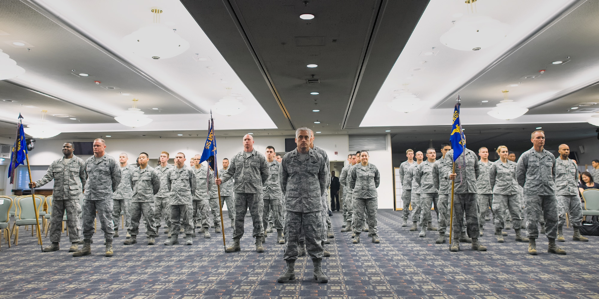 YOKOTA AIR BASE, Japan -- Airmen from the 730th Air Mobility Squadron stand in formation for the 515th Air Mobility Operations Group change of command ceremony at Yokota Air Base, Japan, on June 28, 2012. The Airmen observed the time-honored tradition as the group leadership changed from Col. Robert Ricci to the new commander, Col. Kenneth Brownell. (U.S. Air Force photo by Osakabe Yasuo)