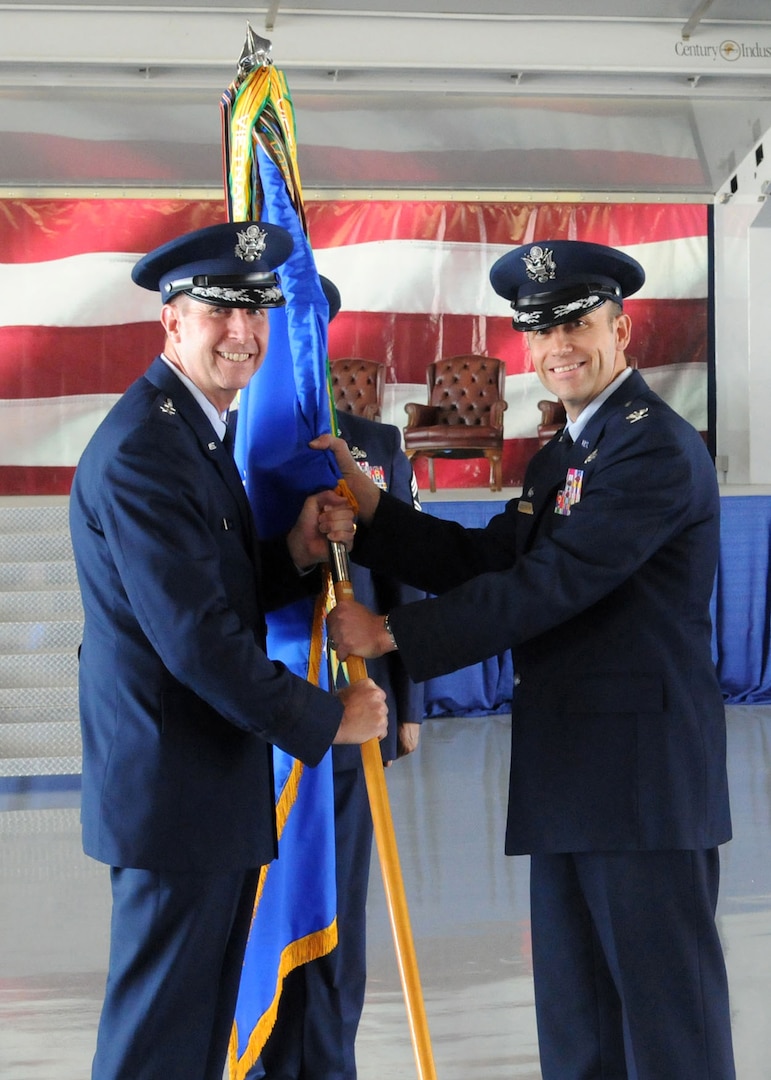 Col. Gerald Goodfellow accepts the 12th Flying Training Wing Flag from Maj. Gen. Mark Solo, 19th Air Force commander, marking Goodfellow's assumption of command at Joint Base San Antonio-Randolph, Texas, June 28. Goodfellow was previously the vice commander for the 7th Bomb Wing at Dyess Air Force Base, Texas. Solo presided over the change of command ceremony. (U.S. Air Force photo by Melissa Peterson)
