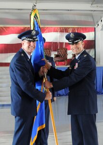 Col. Gerald Goodfellow accepts the 12th Flying Training Wing Flag from Maj. Gen. Mark Solo, 19th Air Force commander, marking Goodfellow's assumption of command at Joint Base San Antonio-Randolph, Texas, June 28. Goodfellow was previously the vice commander for the 7th Bomb Wing at Dyess Air Force Base, Texas. Solo presided over the change of command ceremony. (U.S. Air Force photo by Melissa Peterson)