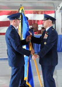 Col. Richard Murphy presents the 12th Flying Training Wing flag to Maj. Gen. Mark Solo, 19th Air Force commander, marking Murphy's relinquishment of command at Joint Base San Antonio-Randolph, Texas, June 28. Murphy relinquished command to Col. Gerald Goodfellow who was previously the vice commander for the 7th Bomb Wing at Dyess Air Force Base, Texas. Solo presided over the change of command ceremony. (U.S. Air Force photo by Melissa Peterson)