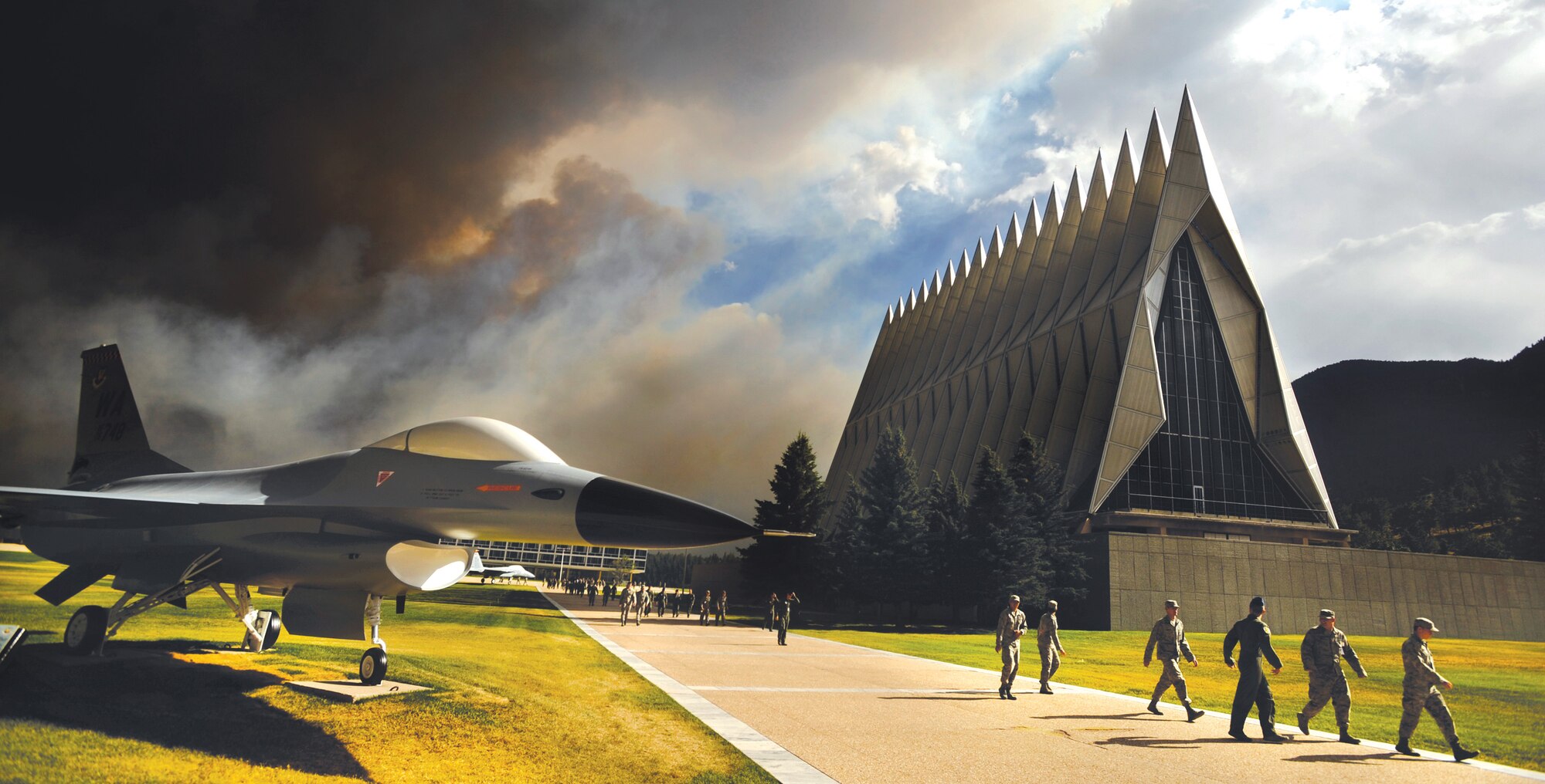 An ominous cloud of smoke from the Waldo Canyon Fire rises from the south behind the Air Force Academy's Cadet Chapel as cadets head for a briefing on evacuation procedures June 27, 2012. The Academy evacuated more than 600 families and 110 dormitory residents from the base the evening of June 27. (U.S. Air Force photo/Carol Lawrence)