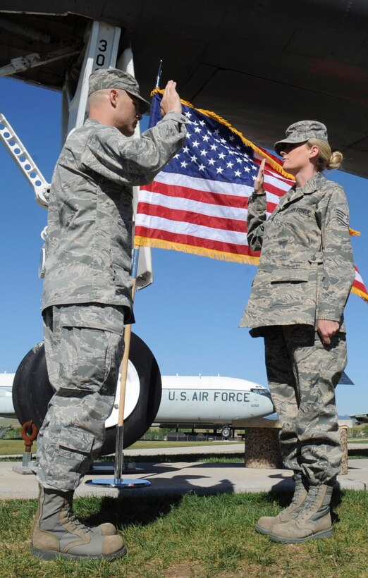 Maj. Nicholas Pedersen, 28th Maintenance Squadron commander, re-enlists his sister, Staff Sgt. Christine Green, 28th Logistics Readiness Squadron NCO in charge of inventory, at the South Dakota Air and Space Museum in Box Elder, S.D., June 21, 2012. Pedersen considers it a great honor to have the opportunity to participate in such an important event in his sister’s life. (U.S. Air Force photo by Airman 1st Class Anania Tekurio/Released) 