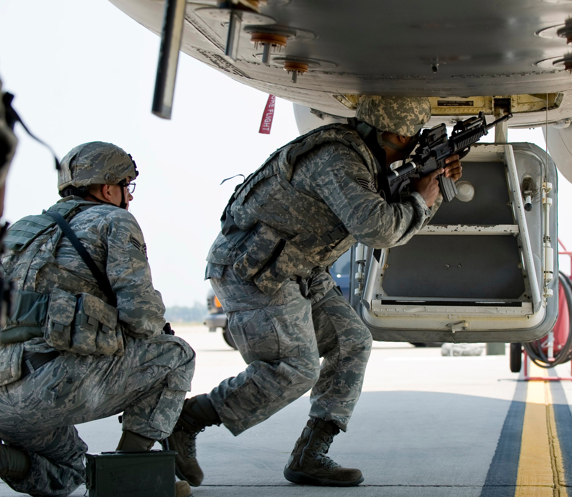 A 2nd Security Forces Squadron Airman enters a B-52H Stratofortress during a training scenario at Barksdale Air Force Base, La., June 26. During the scenario, 2 SFS Airmen swept and cleared the entire aircraft of enemy forces and improvised explosive devices. (U.S. Air Force photo/Staff Sgt. Chad Warren)(RELEASED)