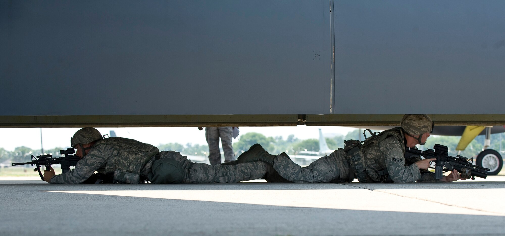 Two 2nd Security Forces Squadron Airmen defend the bomb bay of a B-52H Stratofortress during a training scenario at Barksdale Air Force Base, La., June 26. Airmen from the 2 SFS train regularly to maintain the highest level of readiness in the event of a real-world situation.  (U.S. Air Force photo/Staff Sgt. Chad Warren)(RELEASED)