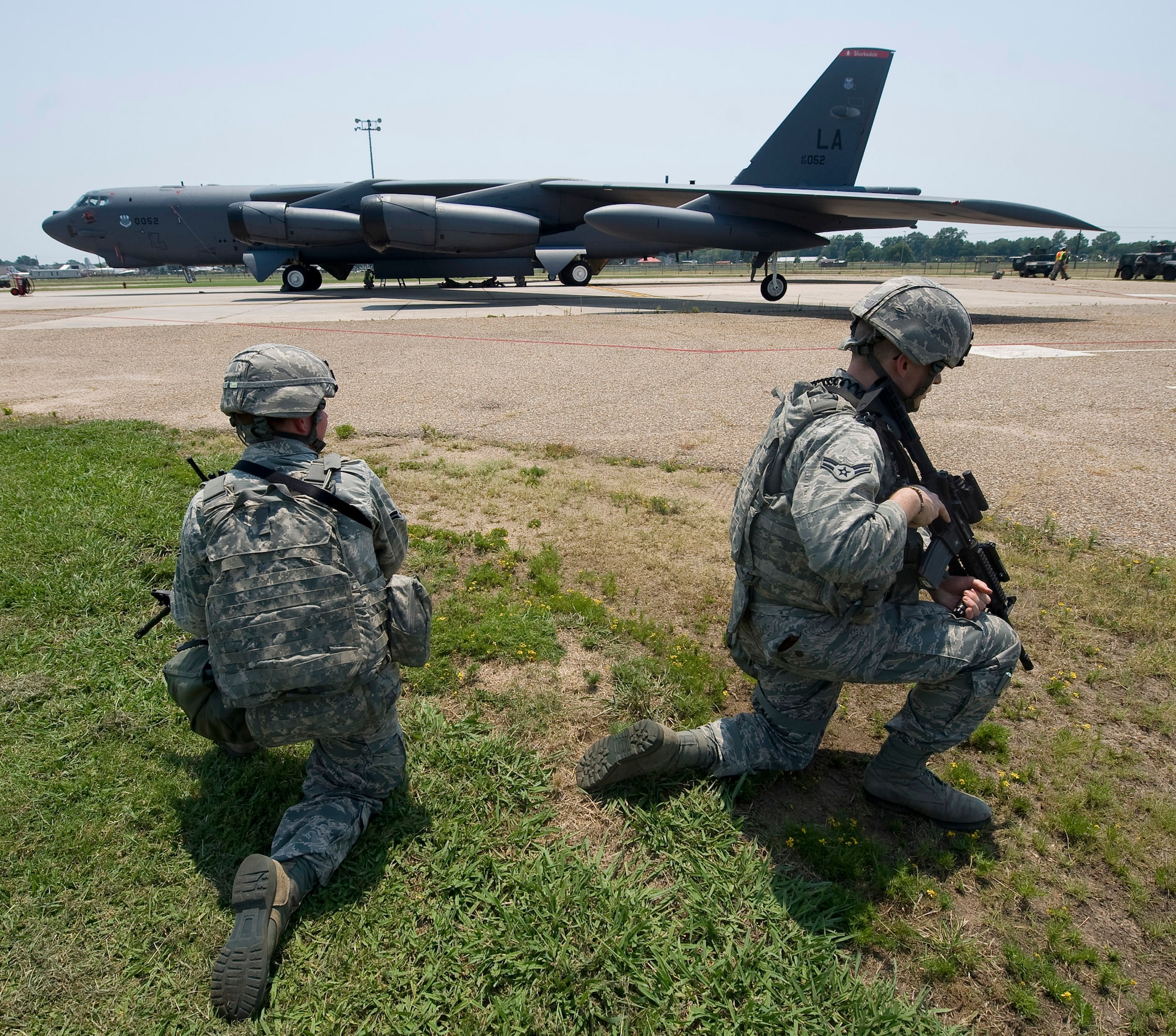 Two 2nd Security Forces Squadron Airmen provide security during a training scenario at Barksdale Air Force Base, La., June 26. This scenario, part of a Nuclear Surety Exercise, evaluated the wing's ability to defend and recover a B-52H Stratofortress carrying simulated strategic weapons. (U.S. Air Force photo/Staff Sgt. Chad Warren)(RELEASED)