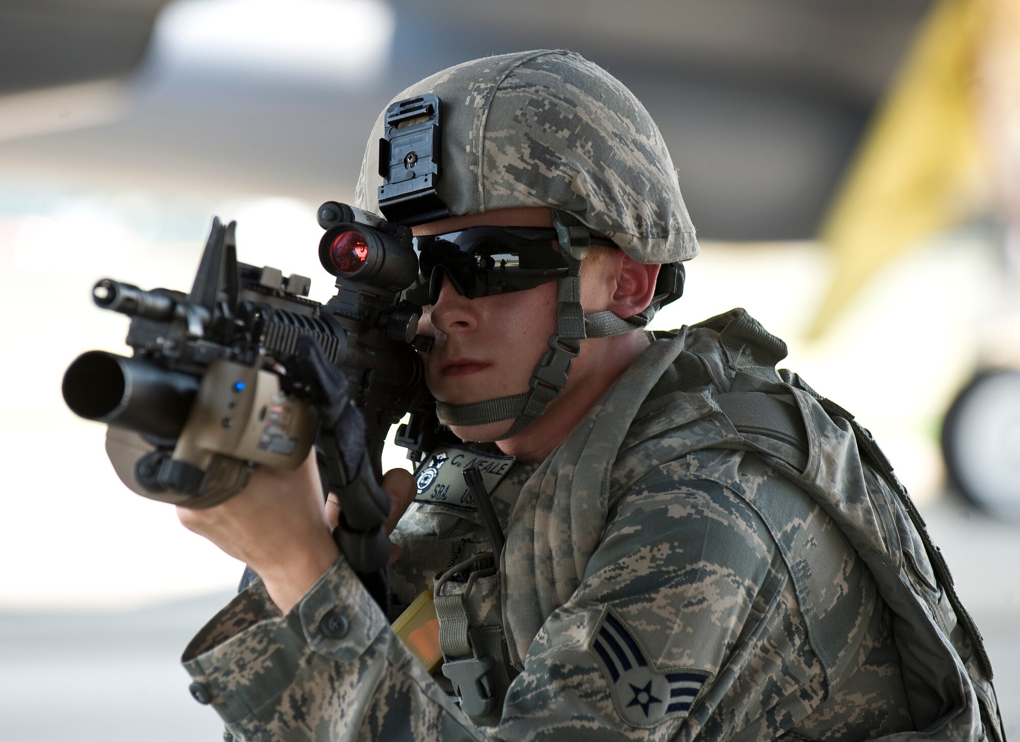 Senior Airman Cody Neale, 2nd Security Forces Squadron, provides cover for Defender teammates under a B-52H Stratofortress during a training scenario at Barksdale Air Force Base, La., June 26. This scenario, part of a Nuclear Surety Exercise, evaluated the wing's ability to defend and recover an aircraft loaded with simulated strategic weapons.  (U.S. Air Force photo/Staff Sgt. Chad Warren)(RELEASED)