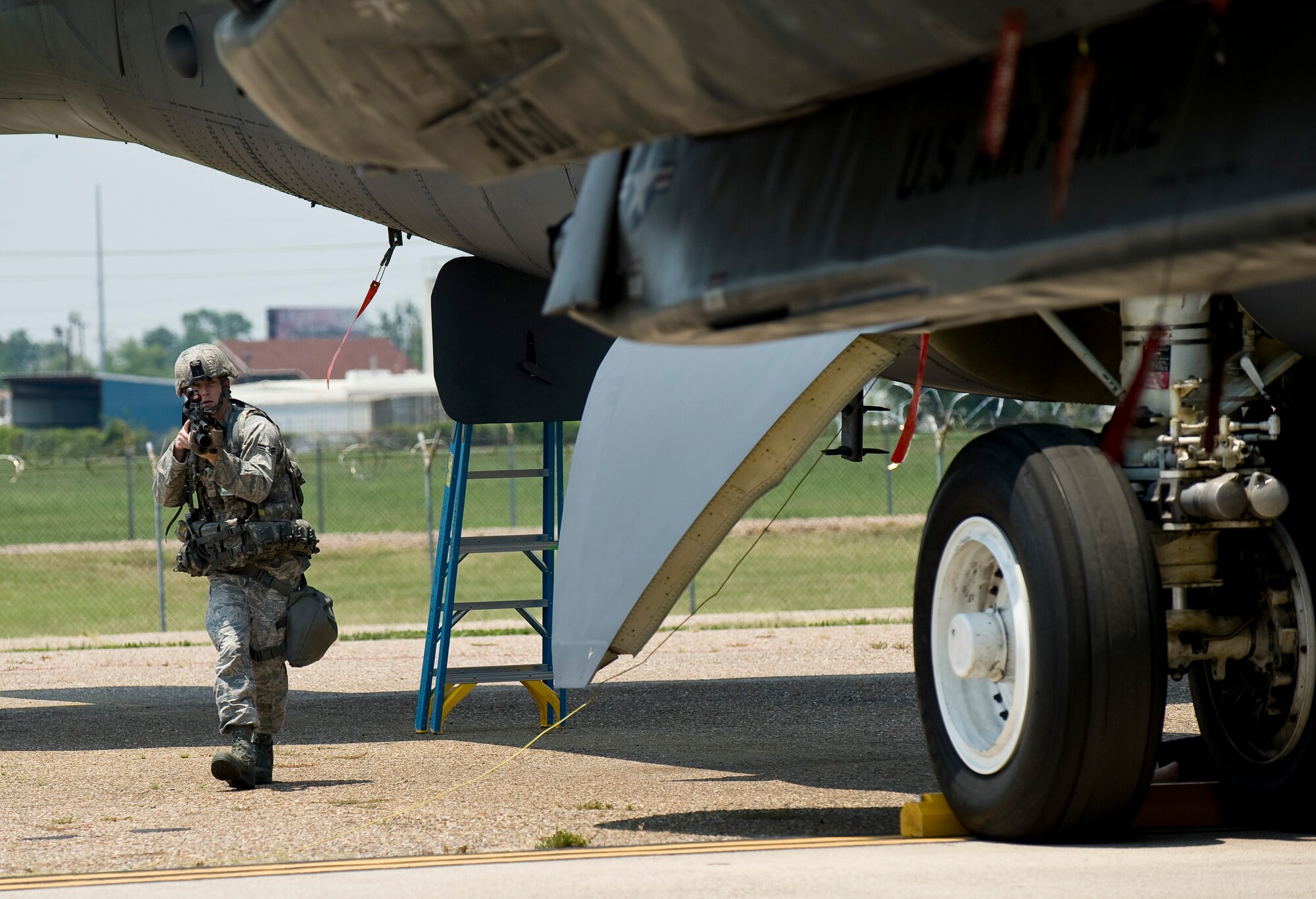 A 2nd Security Forces Squadron Airman rushes to secure a B-52H Stratofortress during a training scenario at Barksdale Air Force Base, La., June 26. Airmen from the 2 SFS train regularly to maintain the highest level of readiness in the event of a real-world situation. (U.S. Air Force photo/Staff Sgt. Chad Warren)(RELEASED)