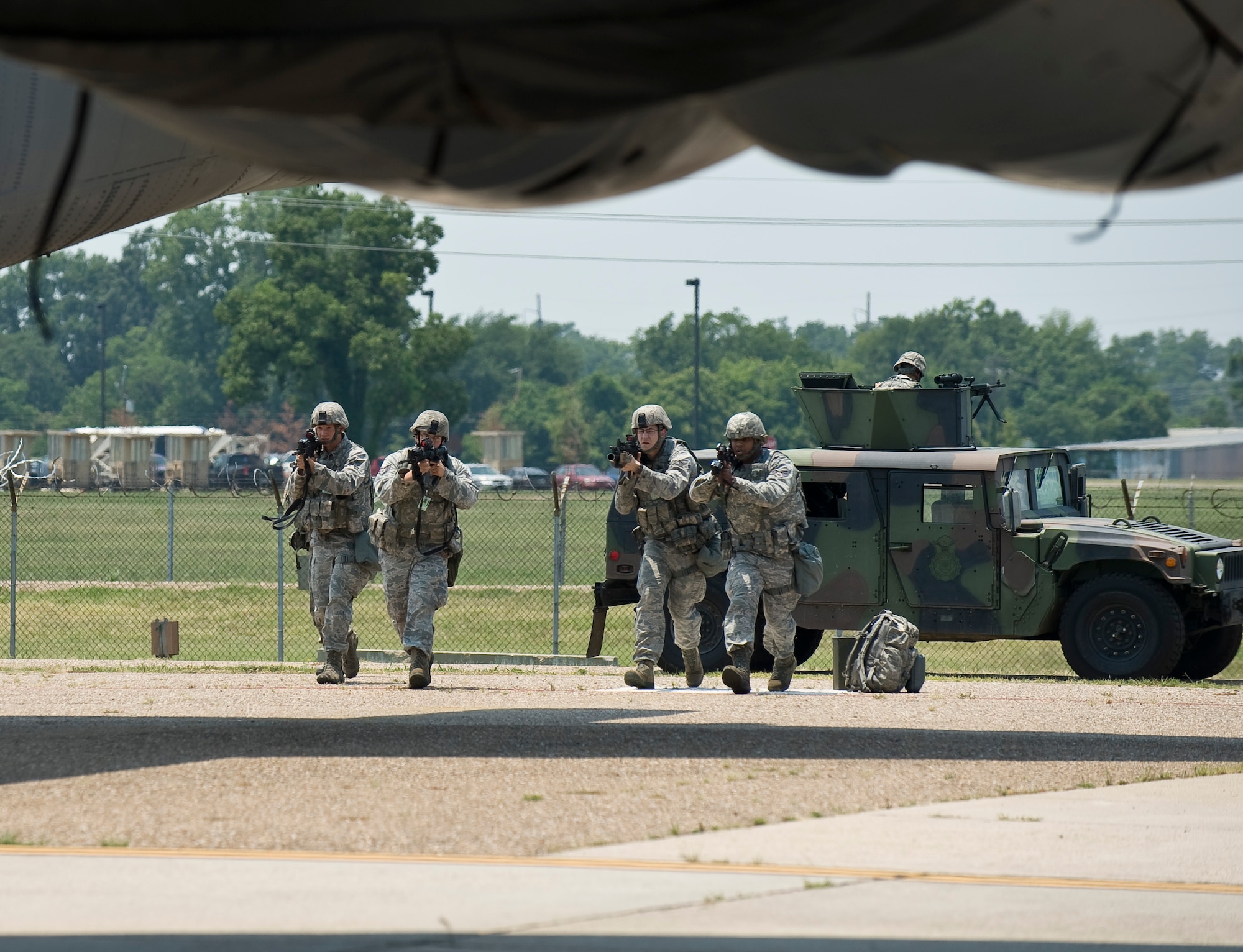 Members of the 2nd Security Forces Squadron rush a B-52H Stratofortress during a training scenario at Barksdale Air Force Base, La., June 26. The scenario was part of a Nuclear Surety Exercise designed to test the wing's ability to maintain control of strategic assets. (U.S. Air Force photo/Staff Sgt. Chad Warren)(RELEASED)