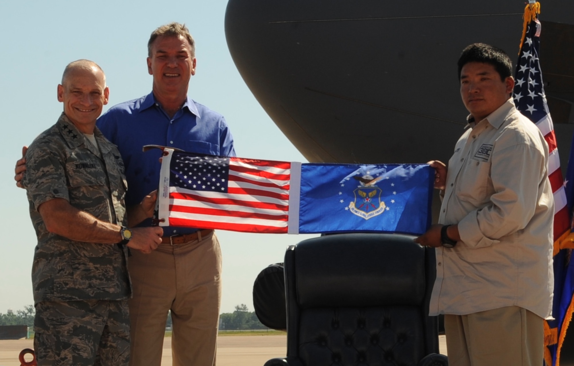 Commander of Air Force Global Strike Command, Lt. Gen. Jim Kowalski, holds the special U.S.-Air Force Global Strike Command flag, along with Chhiring Dorje Sherpa and Tom Whittaker.  Sherpa had personally carried the flag to the summit of Mount Everest in honor of the Global Strike Command Airmen and presented it to the command in a special ceremony here June 27 (U.S. Air Force photo by Airman 1st Class Joseph A. Pagán Jr.).