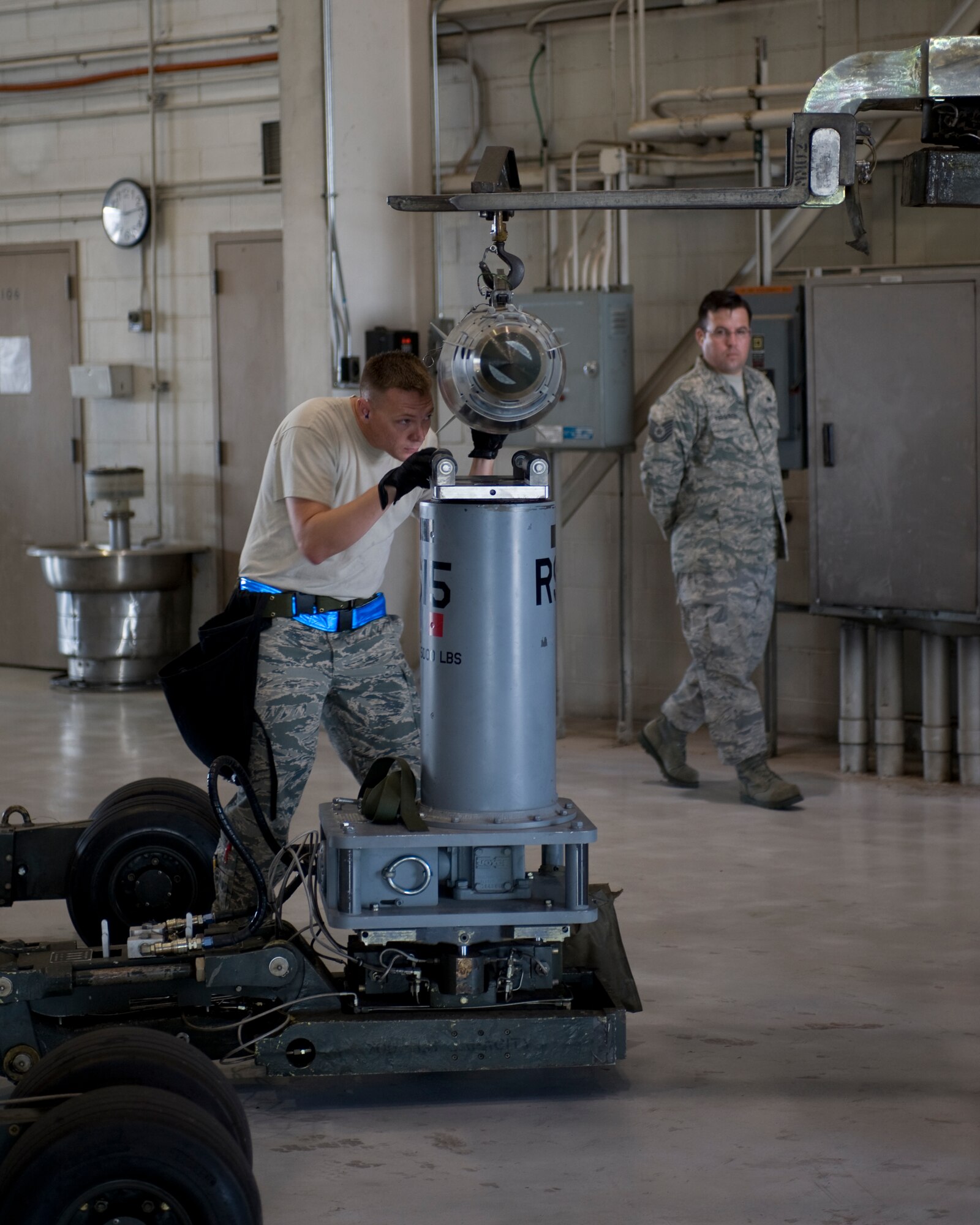 U.S. Air Force Tech. Sgt. Anthony Tucker, left, positions a GBU-38 guided bomb unit on to a lift truck while being evaluated by Tech. Sgt. Blake Ferguson, 7th Aircraft MaintenanceSquadron weapons load crew member during the Weapons Load Crew of the quarter competition held at the load crew training facility June 28, 2012, at Dyess Air Force Base, Texas. The competition was comprised of a dress and appearance inspection, physical fitness test and a timed weapons loading evaluation. (U.S. Air Force photo by Staff Sgt. Richard P. Ebensberger/ Released)
