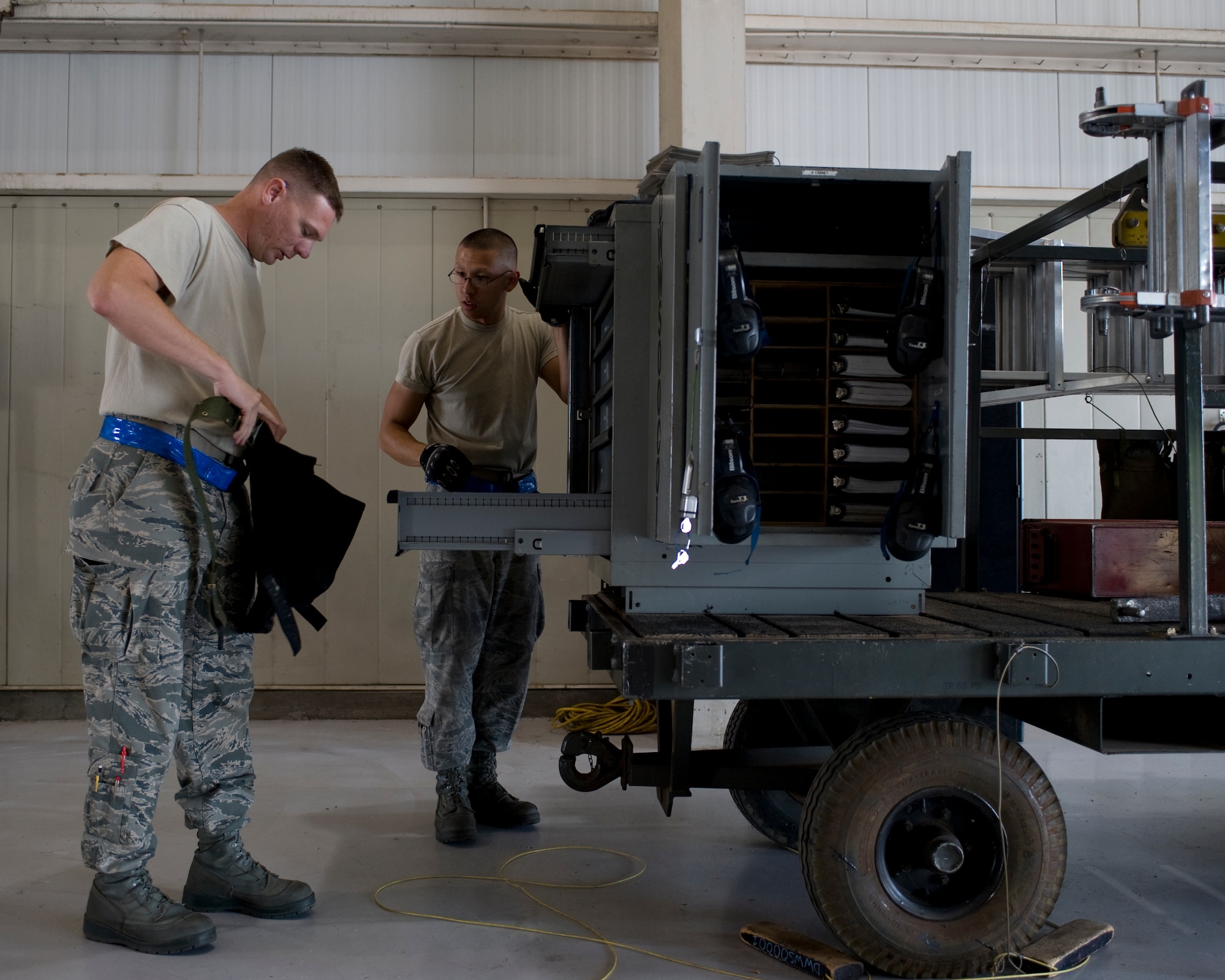 U.S. Air Force Tech. Sgt. Anthony Tucker, left,  and Senior Airman John Smith, 7th Aircraft Maintenance Squadron weapons load crew team members, inspect a composite tool kit during the Weapons Load Crew of the Quarter competition held at the load crew training facility June 28, 2012, at Dyess Air Force Base, Texas. The competition was comprised of a dress and appearance inspection, physical fitness test and a timed weapons loading evaluation. (U.S. Air Force photo by Staff Sgt. Richard P. Ebensberger/ Released)