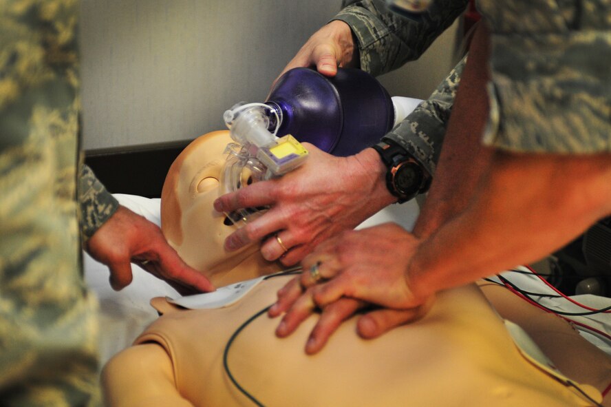 U.S. Air Force Master Sgt. Aramis Cende??o, 27th Special Operations Medical Operations Squadron, Lt. Col. Christopher Walker, 27th Special Operations Medical Group, and Capt. Mark Leedy, 27 SOMDG, practice medical responses on the SimMan 3G in the clinic at Cannon Air Force Base, N.M., June 21, 2012. The SimMan 3G is capable of mimicking nearly any bodily function necessary for the purpose of medical training. (U.S. Air Force photo by Airman 1st Class Alexxis Pons Abascal)