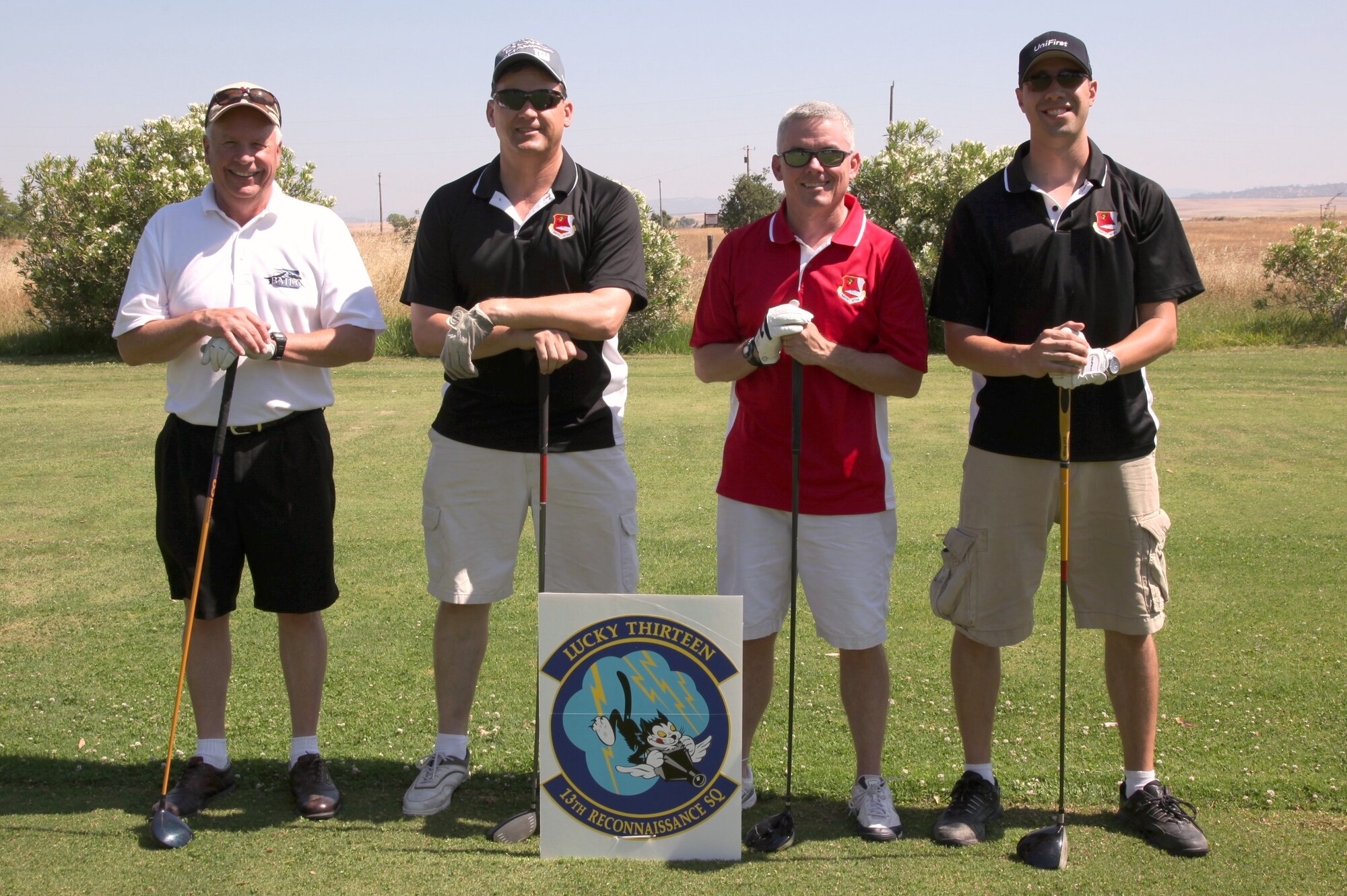 From left to right, Mr. Chuck Cinnamon, Colonel Kevin Cavanagh, Colonel John Trnka, and Major Christopher Steuer pose with clubs behind the 13 Reconnaissance Squadron’s sponsored hole on the Coyote Run golf course during the Top 3’s Annual Golf Tournament, June 1, here.  The Top 3 Organization held their annual golf tournament to help raise funds for wing wide events and ceremonies.  (U.S. Air Force photo by Technical Sgt. Kenneth McCann)