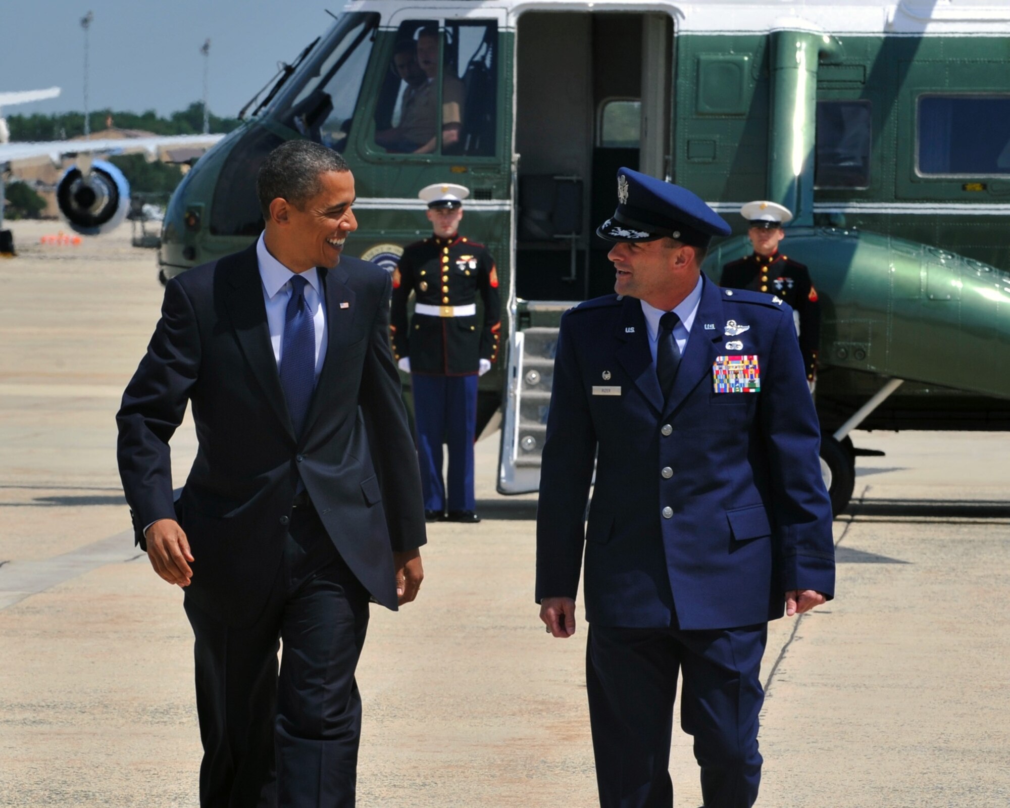 Walking side by side, President Barack Obama and Col. Ken Rizer, 11th Wing/Joint Base Andrews commander, chat on the flightline about the latest football standings. After serving more than 25 years in activeduty military service Rizer will retire in a ceremony here July 6.