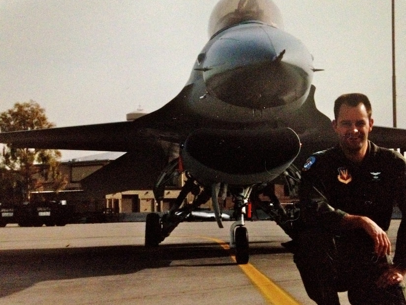 Next to his F-16 Fighting Falcon, Col. Ken Rizer, 11th Wing/Joint Base Andrews commander, poses for a photo. Throughout his career, Rizer gained more than 2,700 flight hours and distinguished himself as an Air Force pilot with various decorations such as: the Aerial Achievement Medal, Air Medal with two oak leaf clusters, Air Force Commendation Medal and the Air Force Achievement Medal with one oak leaf cluster. (Courtesy photo)