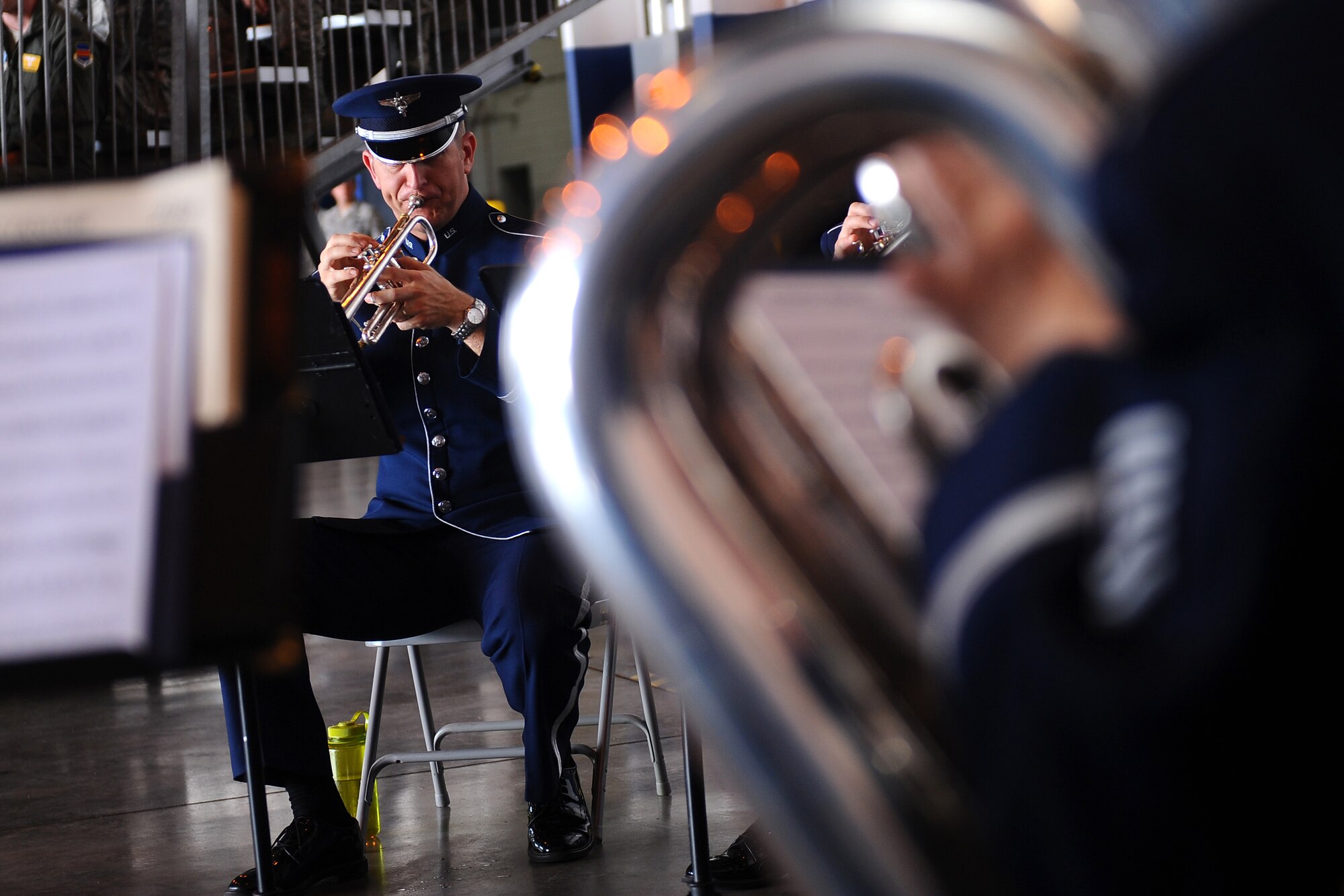 U.S. Air Force Staff Sgt. Carl Eitzen, Heartland of America Band, performs with the Brass in Blue ensemble while guests entered Dock 1 of the Bennie Davis Maintenance Facility June 28 for the 55th Wing Change of Command ceremony on Offutt Air Force Base, Neb.  The change of command marked the end of Brig. Gen. Donald Bacon's command of the wing and the assumption of command by Col. John Rauch.  (U.S. Air Force Photo by Josh Plueger/Released)
