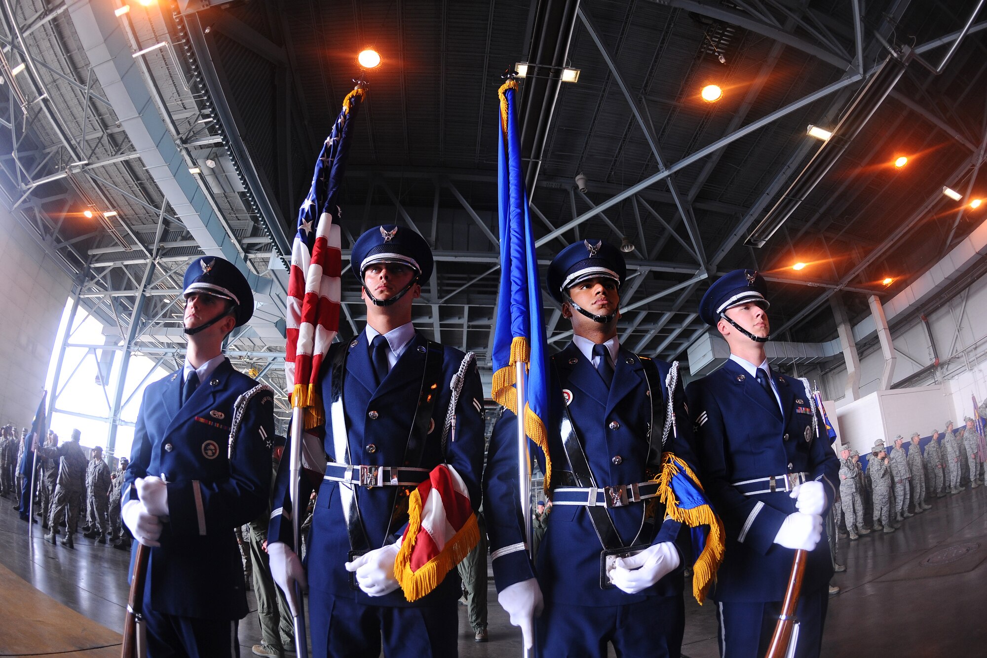 The Offutt Air Force Base Honor Guard stands ready to post the colors at the 55th Wing change of command ceremony held inside Dock 1 of the Bennie Davis Maintenance Facility June 28 on Offutt Air Force Base, Neb.  Members of Team Offutt assembled to witness the time-honored tradition of the passing of the guidon from the outgoing commander to the incoming.  (U.S. Air Force Photo by Josh Plueger/Released)
