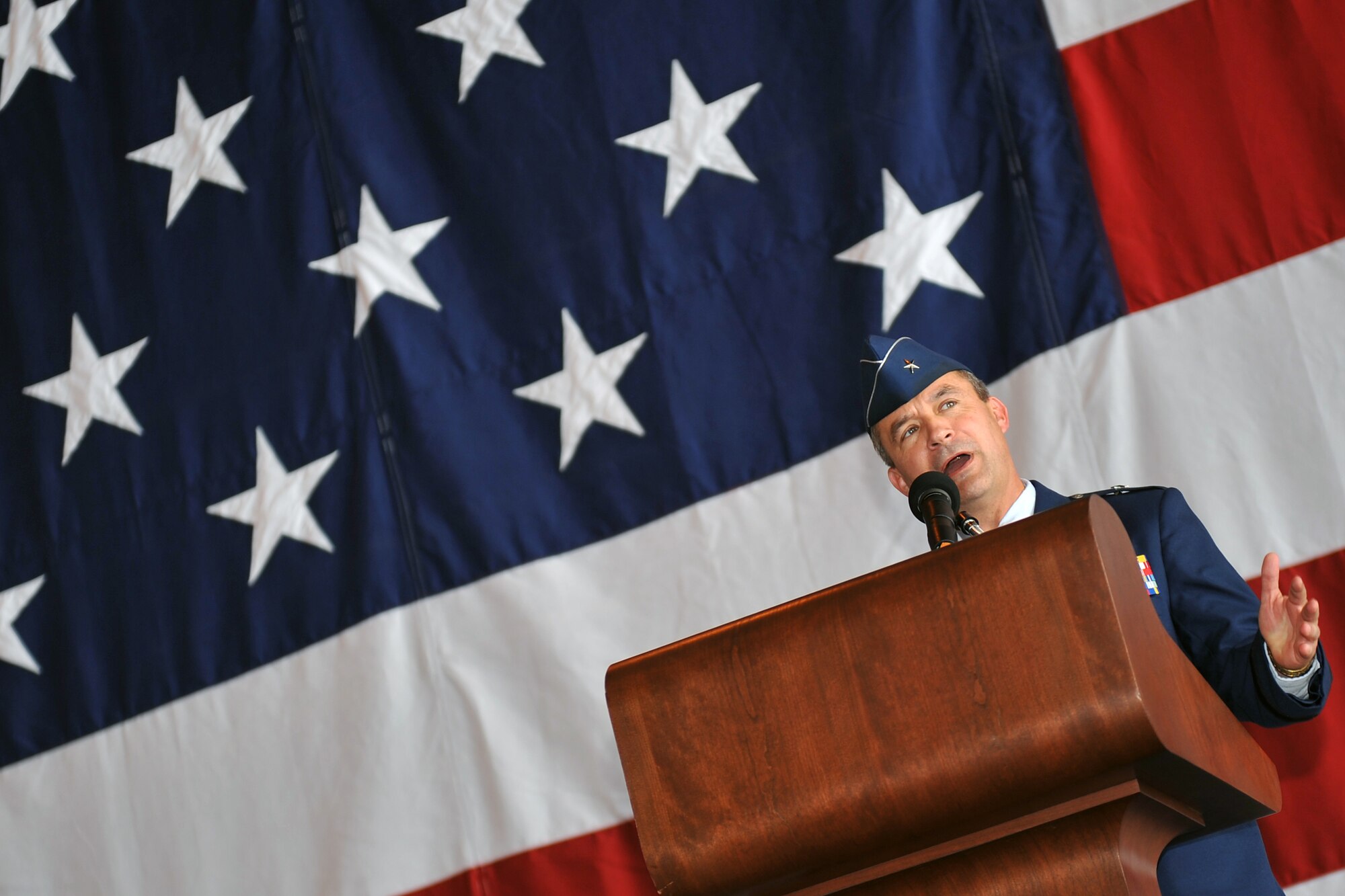 Brig. Gen. Donald Bacon, outgoing 55th Wing commander, says a few words before departing during a formal change of command ceremony in Dock 1 of the Bennie Davis Maintenance Facility at Offutt Air Force Base, Neb. June 28.  Bacon took command of the wing in March 2011 and will now act as the director of intelligence, surveillance and reconnaissance strategy, plans, doctrine and force development at the Pentagon. (U.S. Air Force photo by Jeff W. Gates/Released)