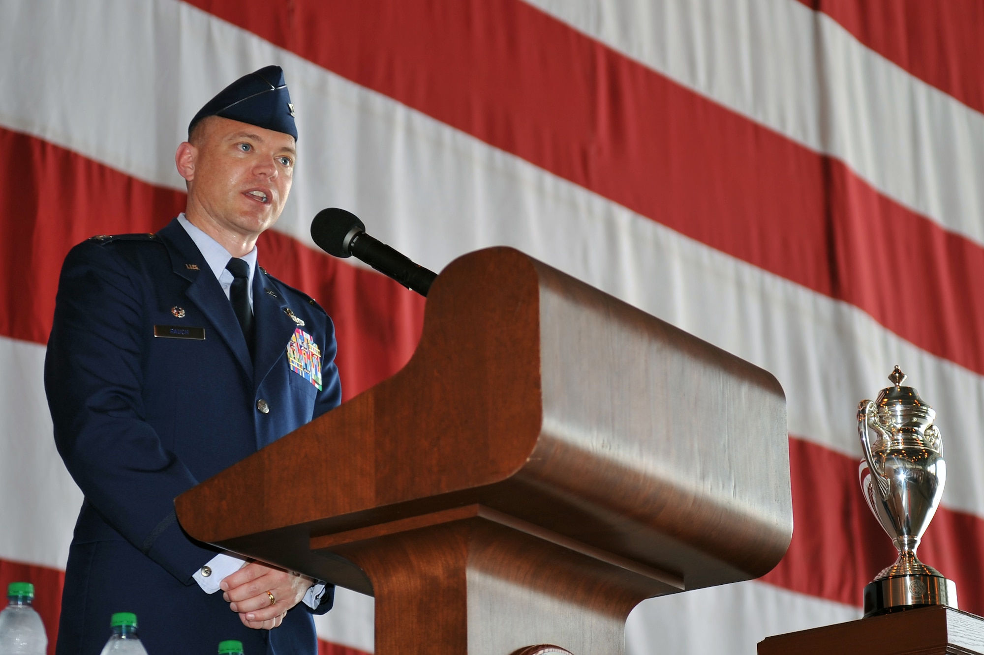 Col. John T. Rauch, incoming 55th Wing commander, gives his remarks, during a formal change of command ceremony in Dock 1 of the Bennie Davis Maintenance Facility June 28 at Offutt Air Force Base, Neb. Rauch is a master navigator with more than 3,000 hours in the RC-135U/V/W, T-43 and E-3B/C. (U.S. Air Force photo by Jeff W. Gates/Released)