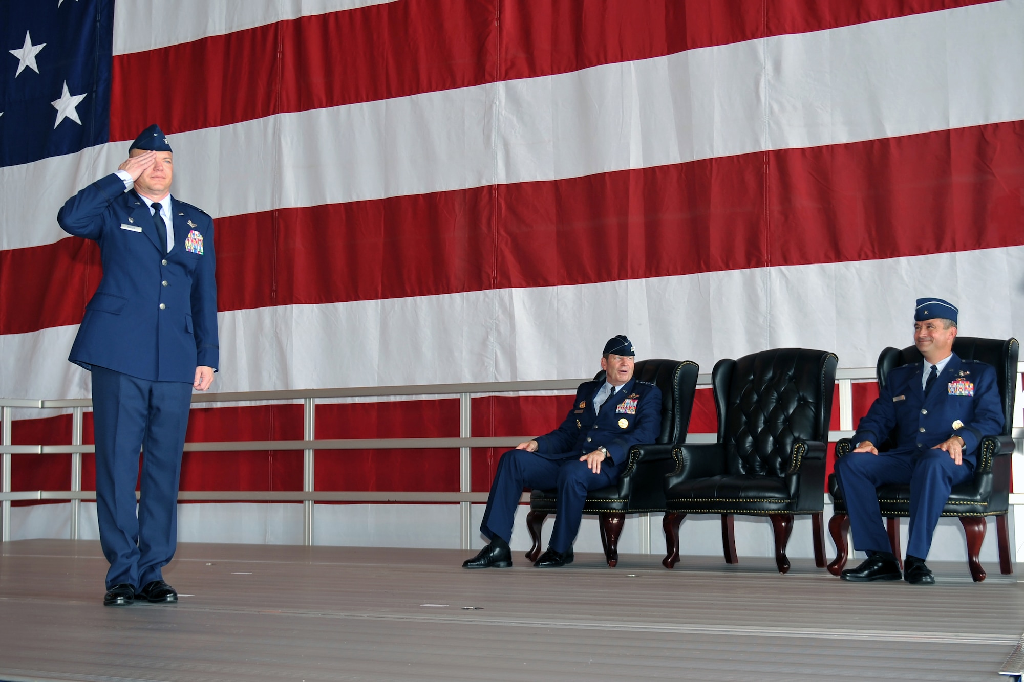 Col. John T. Rauch, new 55th Wing commander, gives his first salute to the flagship RC-135, during a formal change of command ceremony in Dock 1 of the Bennie Davis Maintenance Facility June 28 at Offutt Air Force Base, Neb.  Rauch is coming from Tinker AFB, Okla., where he served as the 552d Air Control Wing commander. (U.S. Air Force photo by Jeff W. Gates/Released)