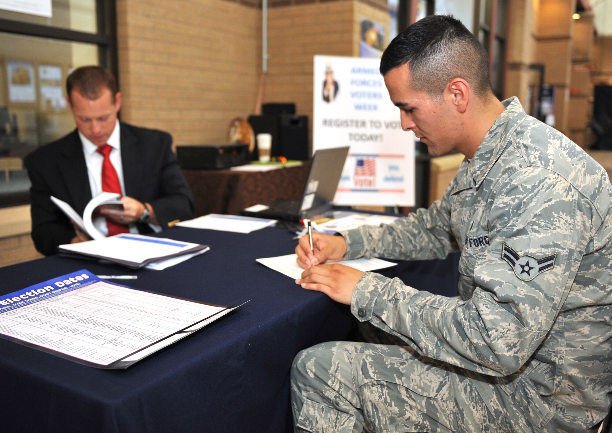 Airman 1st Class Andres Gonzalez, 22nd Aircraft Maintenance Squadron communications navigation journeyman, registers to vote at the Robert J. Dole Community Center June 28, 2012, McConnell Air Force Base, Kan.  The installation voting assistance office registers Airmen and encourages 100 percent voter registration. (U.S. Air Force photo/Airman 1st Class Maurice A. Hodges) 