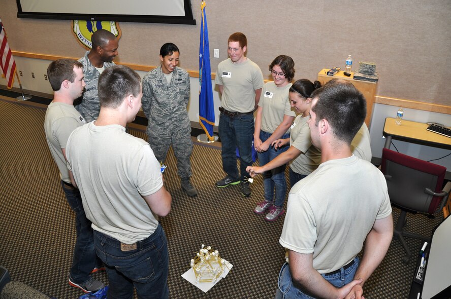 Staff Sgt. Jessica Harrell, 442nd Development and Training Flight supervisor, listens to trainees of the 442nd DTF describe the vision behind their marshmallow towers that were built as a team building exercise during the June 2012 unit training assembly.  The 442nd DTF is part of the 442nd Fighter Wing, an A-10 Thunderbolt II Air Force Reserve unit at Whiteman Air Force Base, Mo. (U.S. Air Force photo/Tech. Sgt. Kent Kagarise)   