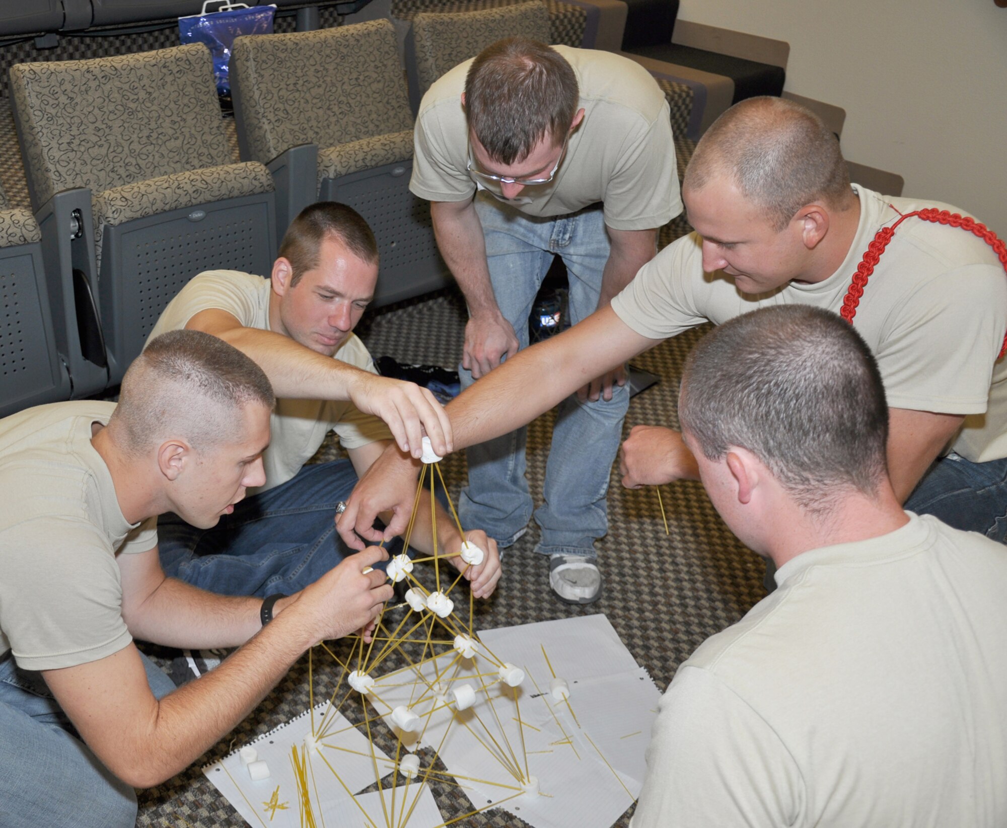 Wearing the red rope, Kevin Meives, a trainee in the 442nd development and training flight, gives his team guidance as they build a marshmallow tower to be judged by instructors on: height, strength, appearance and the story for how it was constructed for a team building exercise during the June 2012 unit training assembly. The 442nd DTF is part of the 442nd Fighter Wing, an A-10 Thunderbolt II Air Force Reserve unit at Whiteman Air Force Base, Mo. (U.S. Air Force photo/Tech. Sgt. Kent Kagarise)   