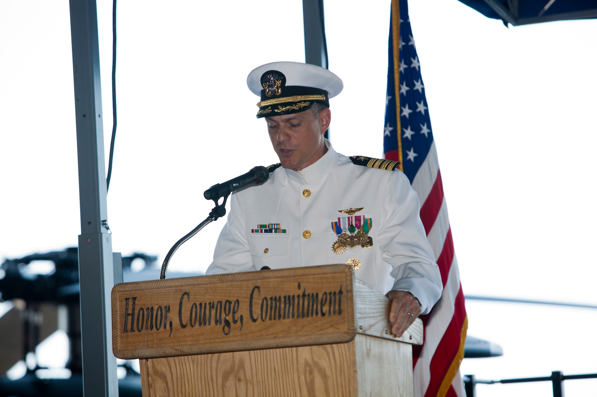 Navy Capt. William A. Bulis reads his orders and assumes command of Naval Support Activity Lakehurst from Capt. Andrew A. Butterfield during the NSA Lakehurst change of command ceremony June 21 at the Westfield Hangar. Bulis also assumed the Joint Base McGuire-Dix-Lakehurst deputy position. (U.S. Air Force photo by Wayne Russell/Released)
