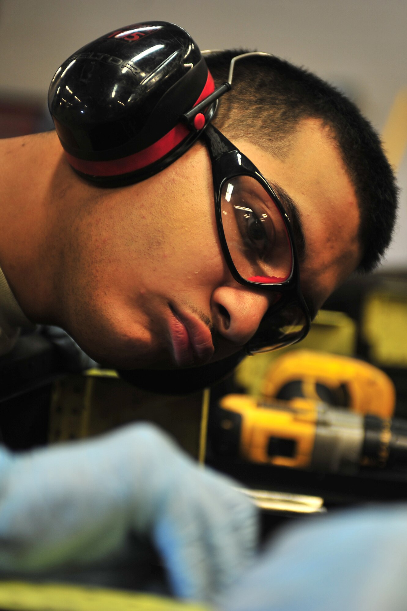 U.S. Air Force Airman 1st Class Bryan Delgado, 27th Special Operations Maintenance Squadron, examines repair work done on an external fuel tank pylon for an AC-130W aircraft at Cannon Air Force Base, N.M., June 7, 2012. The purpose of this work is to provide a wind shield when the external fuel tanks are removed from the external fuel tank pylons. (U.S. Air Force photo by Airman 1st Class Eboni Reece)