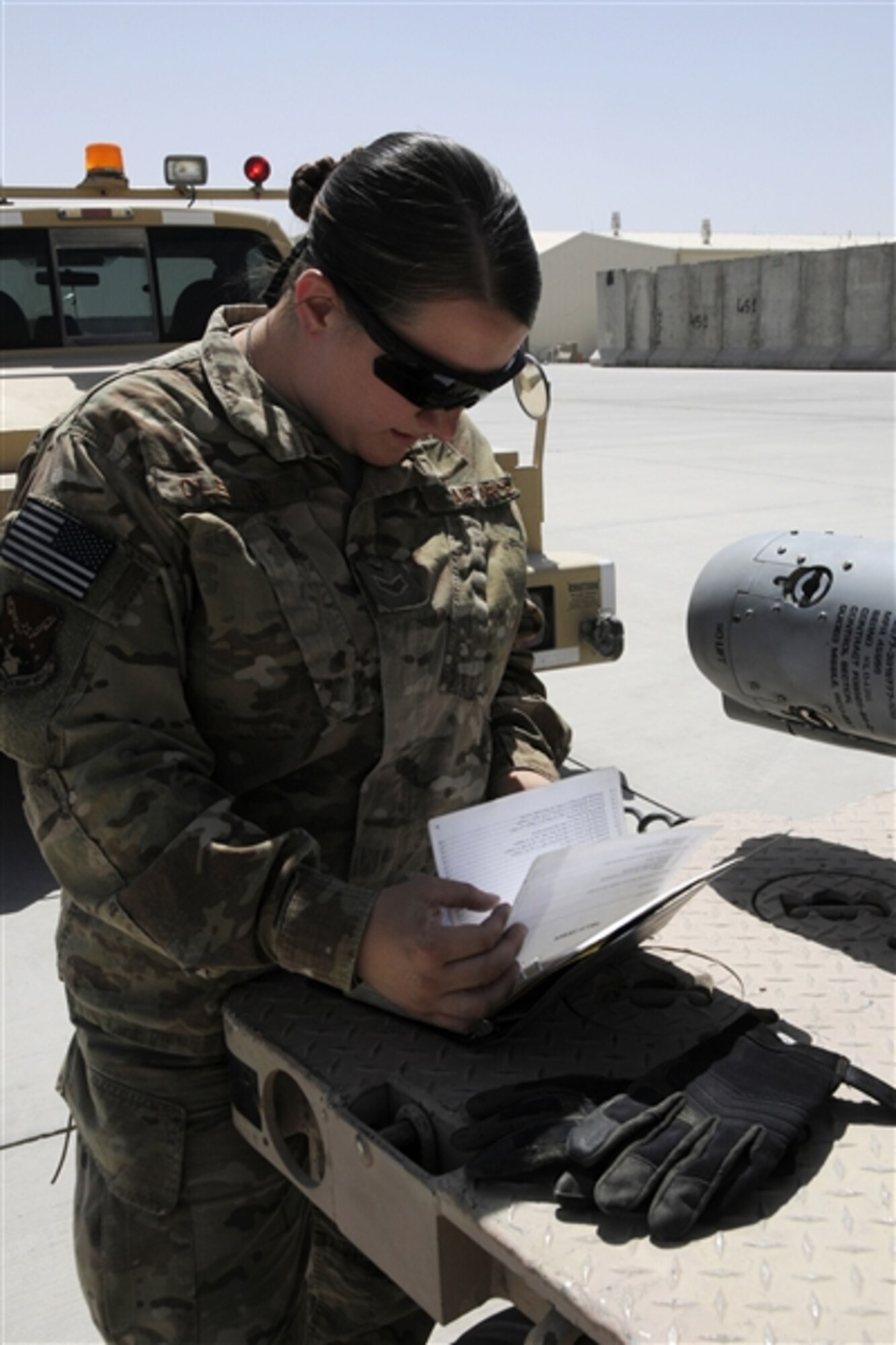 Airman 1st Class Rhiannon O'Leary reviews paperwork during delivery of munitions to the flightline at Kandahar Airfield, Afghanistan, June 14, 2012. U.S. Air Force photo by Tech. Sgt. Stephen Hudson 