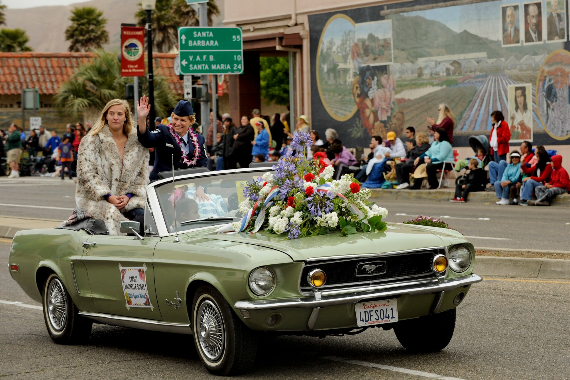 VANDENBERG AIR FORCE BASE, Calif. -- Chief Master Sgt. Michelle Sobel, 30th Medical Group command chief, waves to parade watchers during the city of Lompoc's 60th Annual Flower Festival Saturday, June 23, 2012. The parade is part of a five day celebration of Lompoc?s flower fields and culture. (U.S. Air Force photo/Staff Sgt. Levi Riendeau) 