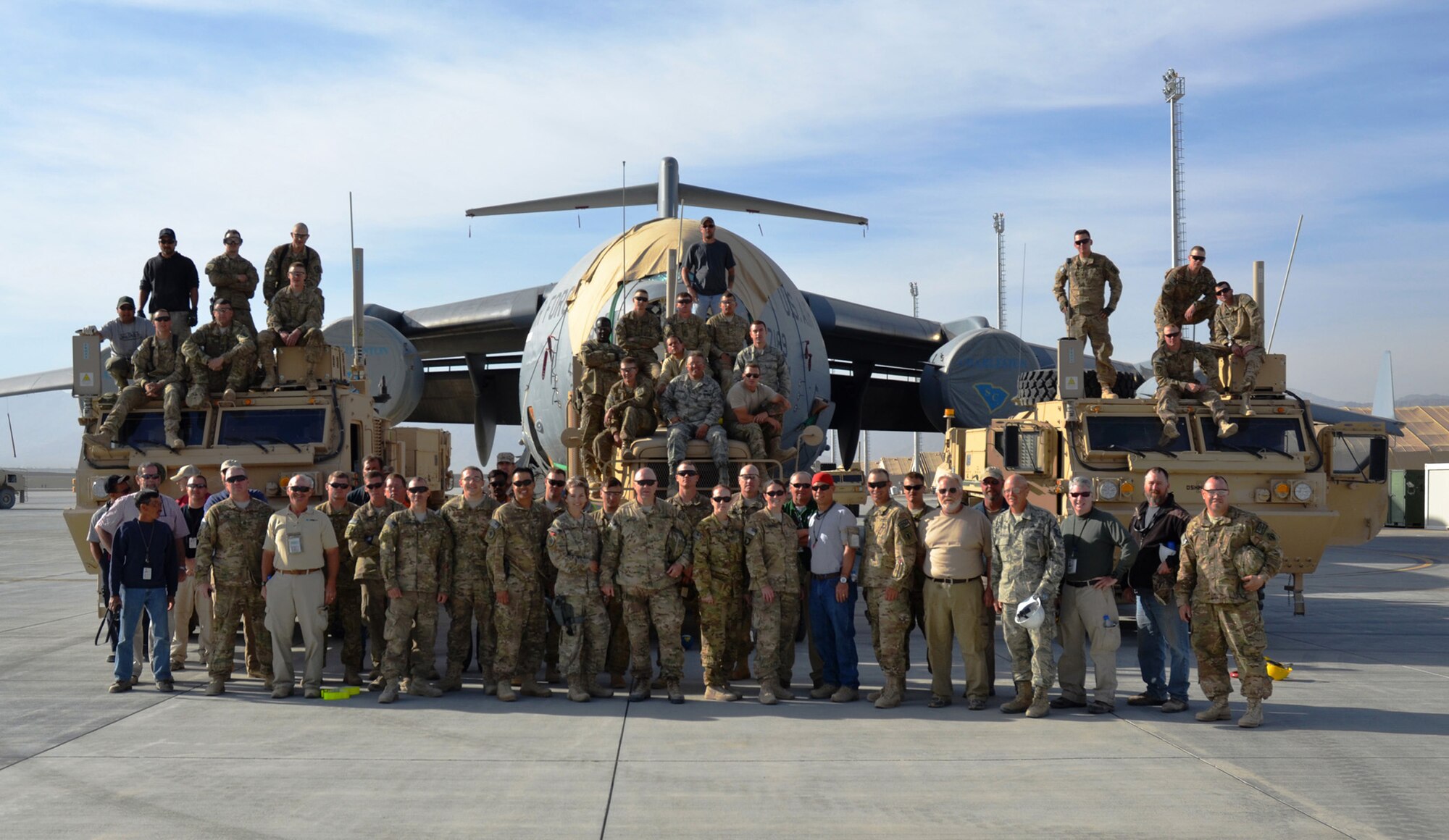 Deployed servicemembers stand in front of the repaired C-17 that was damaged in Afghanistan in January 2012. Senior Master Sgt. Roy Osmon, 446th Aircraft Maintenance Squadron technician, was on the team composed of Airmen, Soldiers and Boeing employees that helped repair and move the damaged aircraft. (Courtesy photo)