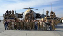 Deployed servicemembers stand in front of the repaired C-17 that was damaged in Afghanistan in January 2012. Senior Master Sgt. Roy Osmon, 446th Aircraft Maintenance Squadron technician, was on the team composed of Airmen, Soldiers and Boeing employees that helped repair and move the damaged aircraft. (Courtesy photo)