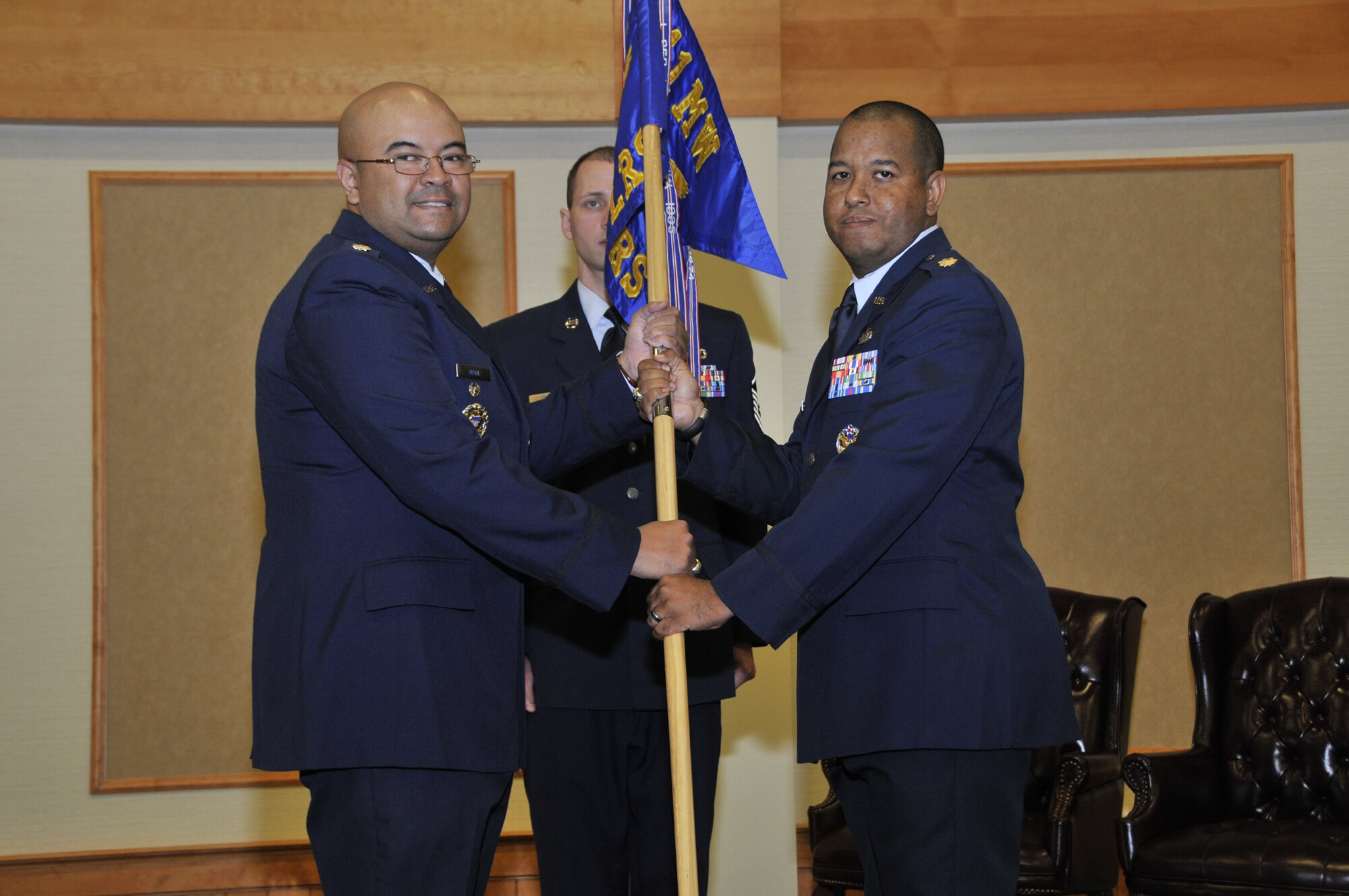 Maj. Eric Gillespie, right, accepts command of the 341st Logistics Readiness Squadron from Lt. Col. William Wade, 341st Mission Support Group deputy commander, June 22 at the Grizzly Bend.  Master Sgt. Bradley Thye, 341st LRS first sergeant, looks on.  (U.S. Air Force photo / John Turner)