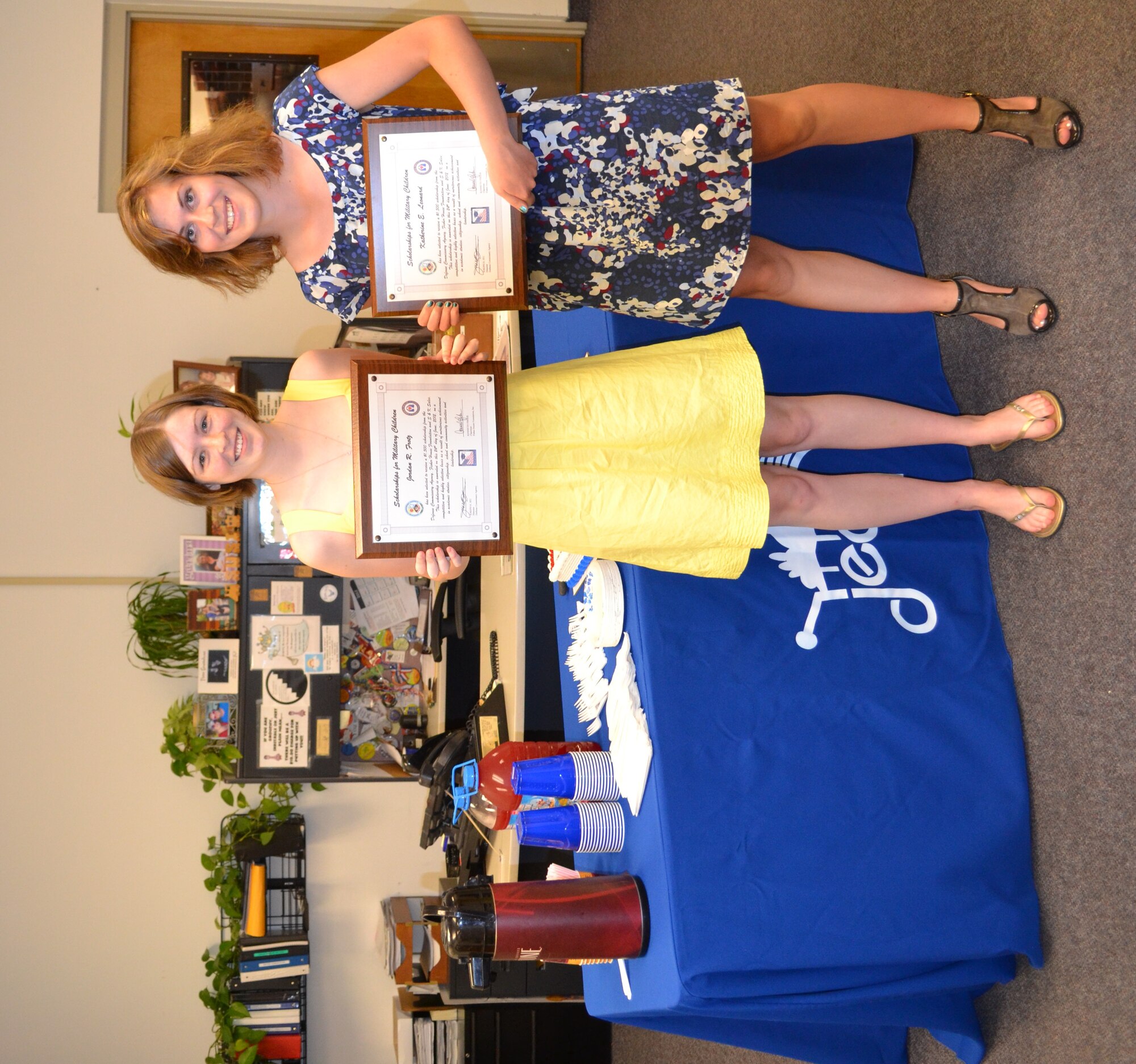Jordan Frotz, Charles M. Russell High School graduate, left, and Katherine Leonard, Great Falls High School graduate, pose with their certificates after being announced two of four local winners of $1,500 scholarships each through the Defense Commissary Agency’s Scholarships for Military Children program during a ceremony held June 24.  Thomas Johnston, Butte High School graduate, and Tayler Halko, Montana State University-Northern junior, both unable to attend the ceremony, were the other two members from Montana who received the scholarship.  (Courtesy photo)