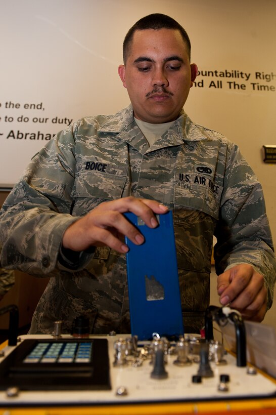 Airman 1st Class Benjamin Boice, 28th Aircraft Maintenance Squadron defensive avionics systems technician, inserts a battery into a radar signal simulator after checking it out in the maintenance support section on Ellsworth Air Force Base, S.D., June 26, 2012. Airmen receiving equipment are required to inspect it to reduce discrepancies when turning in the equipment. (U.S. Air Force photo by Airman 1st Class Kate Thornton/Released)
