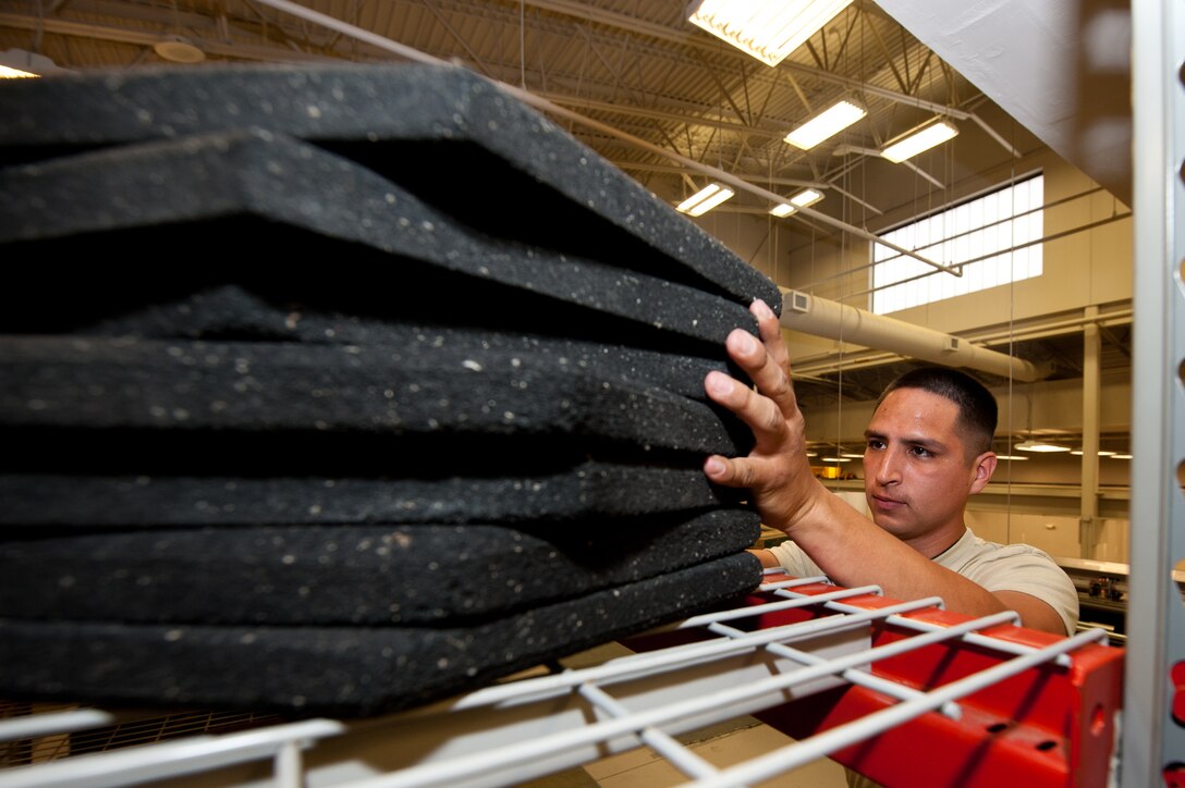 Senior Airman Efren Rangel, 28th Aircraft Maintenance Squadron weapons load crew member, stores a stack of cone bases during an equipment check-in process in the maintenance support section on Ellsworth Air Force Base, S.D., June 26, 2012. The support section provides B-1 maintenance crews with serviceable equipment they need to complete the mission. (U.S. Air Force photo by Airman 1st Class Kate Thornton/Released)